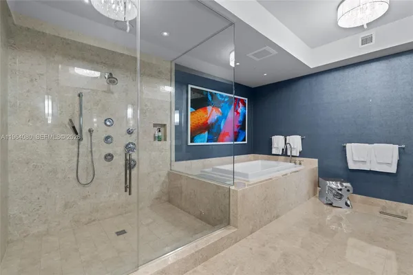 a bathroom with a tub a shower and view of a mirror