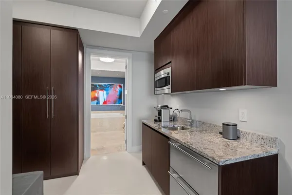 a kitchen with stainless steel appliances granite countertop a sink and cabinets