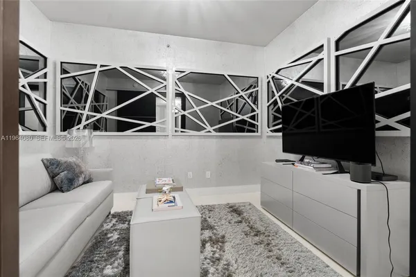 a living room with a couch and chandelier