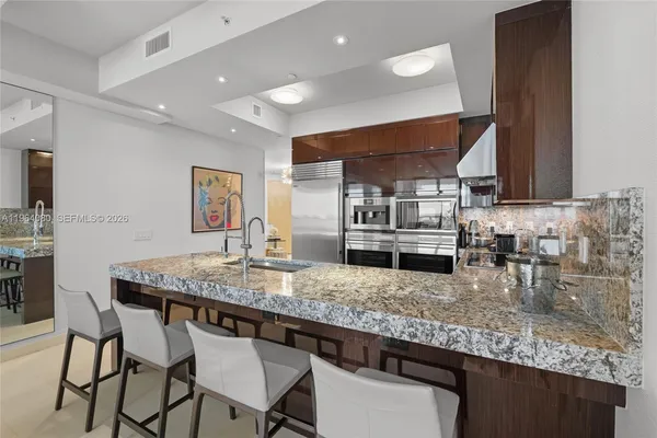 a kitchen with a counter space cabinets and appliances