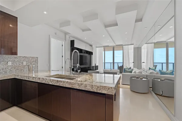 a large kitchen with kitchen island a sink stainless steel appliances and cabinets