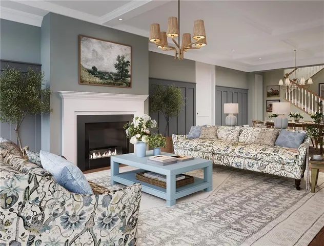 a living room with furniture a fireplace and a chandelier