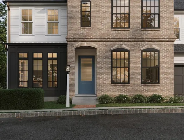 a view of a brick building next to a yard