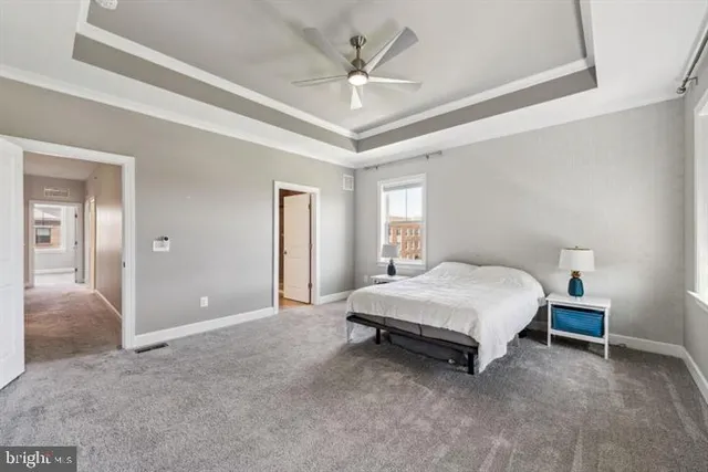 a spacious bedroom with a bed and a ceiling fan