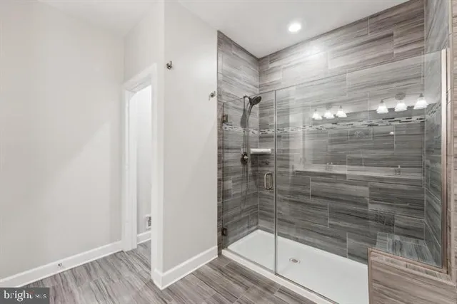 a bathroom with a glass shower door