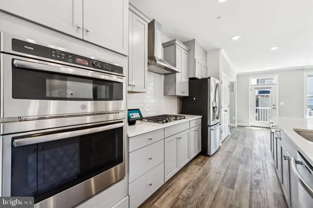 a kitchen with stainless steel appliances and wooden cabinets