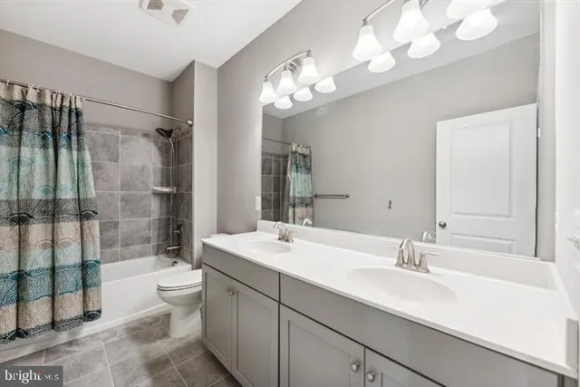 a bathroom with a sink double vanity and a shower