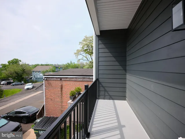 a view of a balcony with chairs and wooden floor