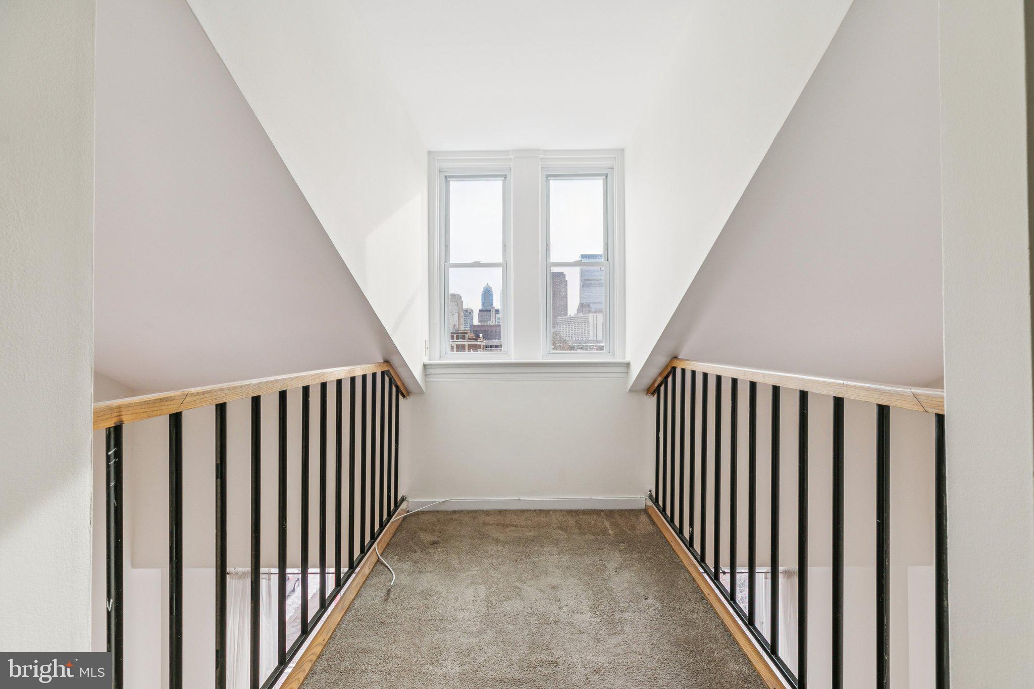 1703 Wallace Street, Unit 301 Philadelphia, PA 19130 - Photo 17 of 22 a view of a hallway with windows