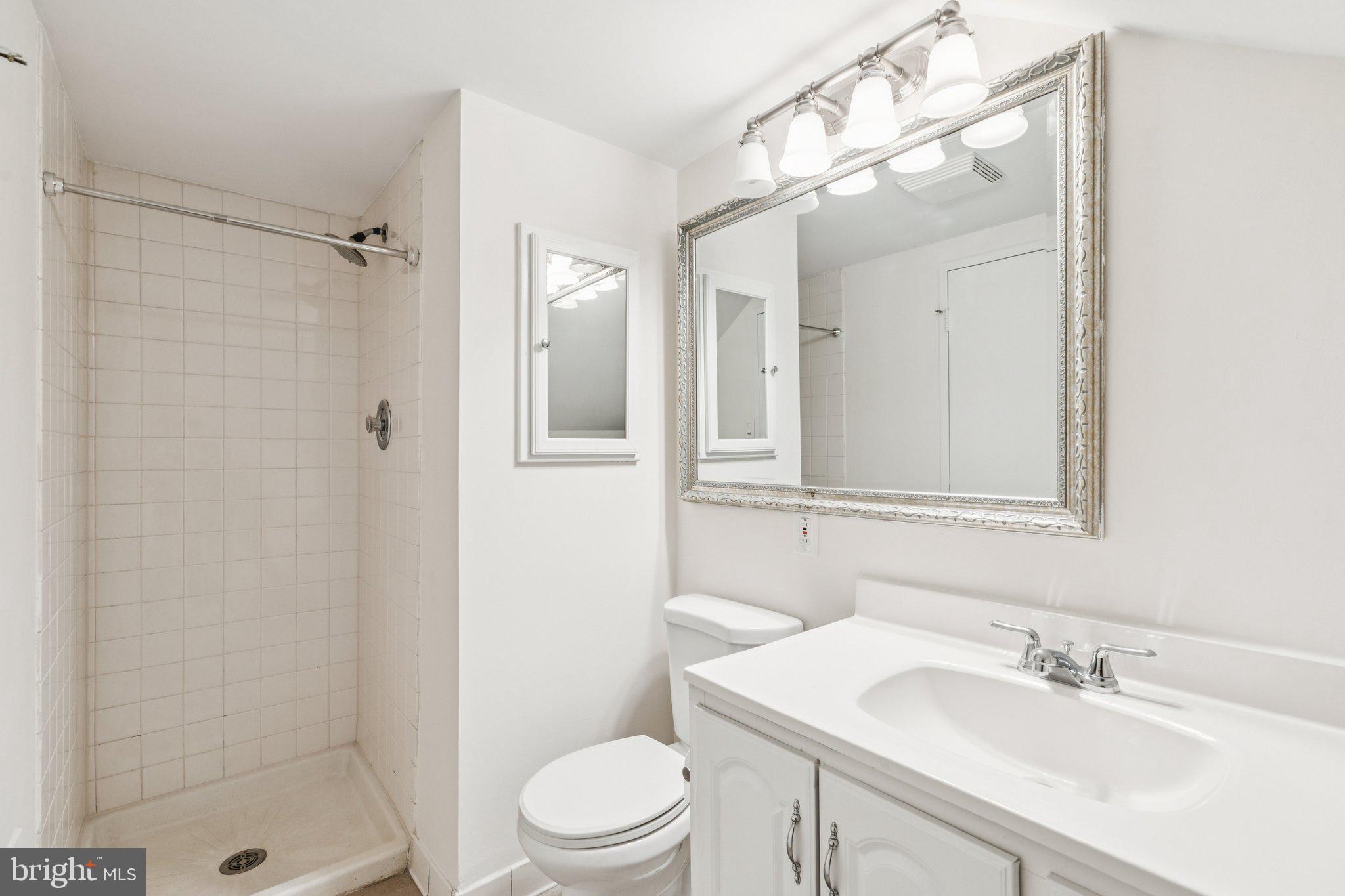 1703 Wallace Street, Unit 301 Philadelphia, PA 19130 - Photo 18 of 22 a bathroom with a sink a toilet and shower