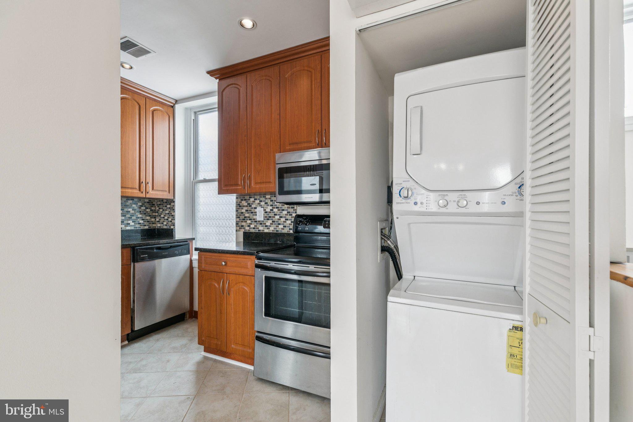 1703 Wallace Street, Unit 301 Philadelphia, PA 19130 - Photo 19 of 22 a kitchen with white cabinets and white appliances