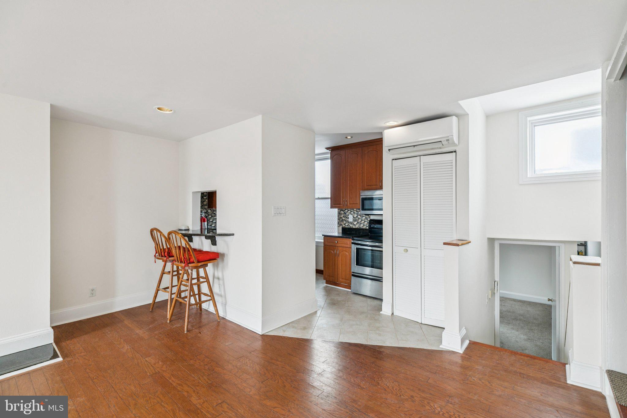 1703 Wallace Street, Unit 301 Philadelphia, PA 19130 - Photo 4 of 22 a view of a room with wooden floor and furniture