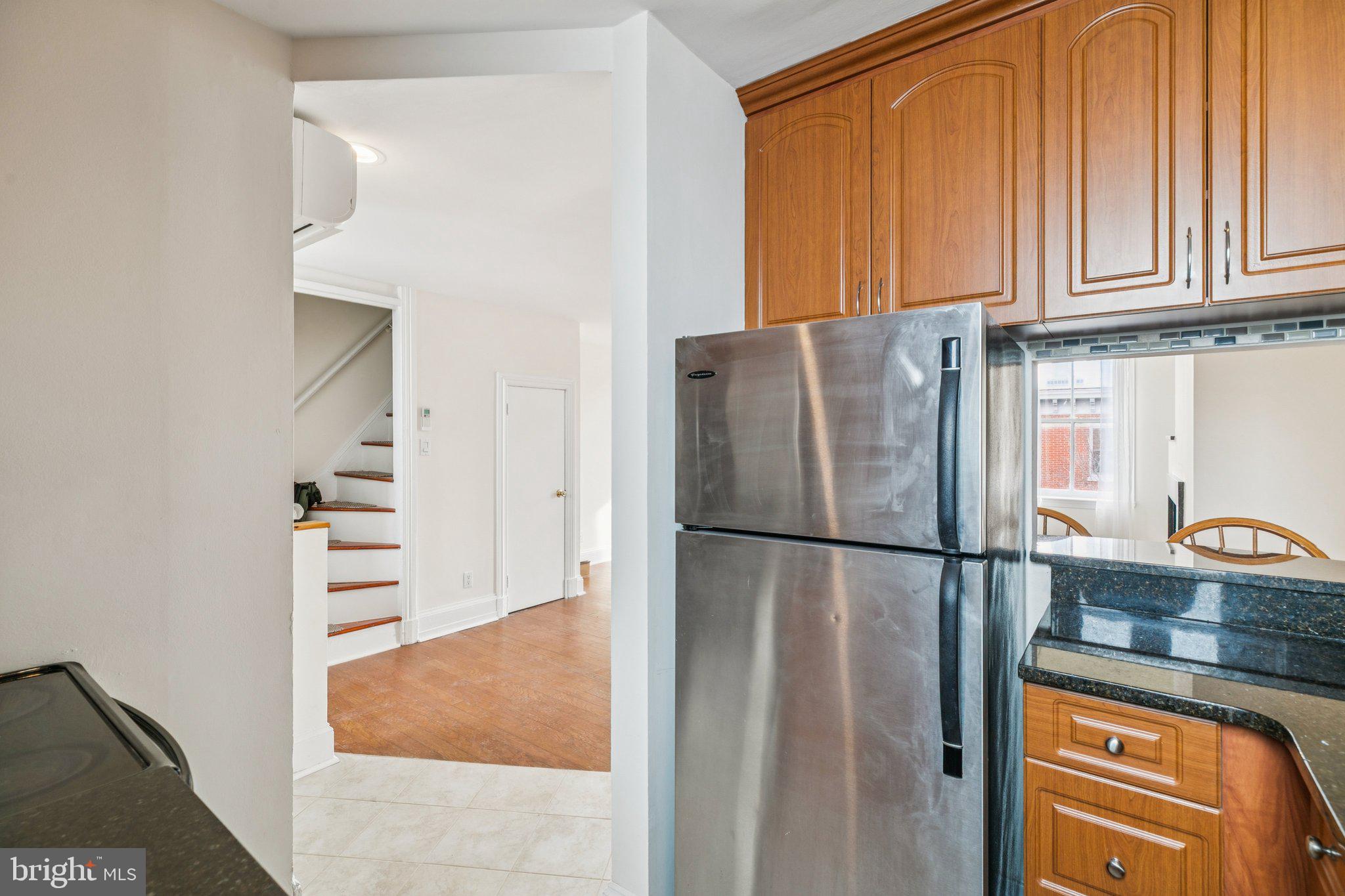 1703 Wallace Street, Unit 301 Philadelphia, PA 19130 - Photo 7 of 22 a white refrigerator freezer and a stove sitting inside of a kitchen