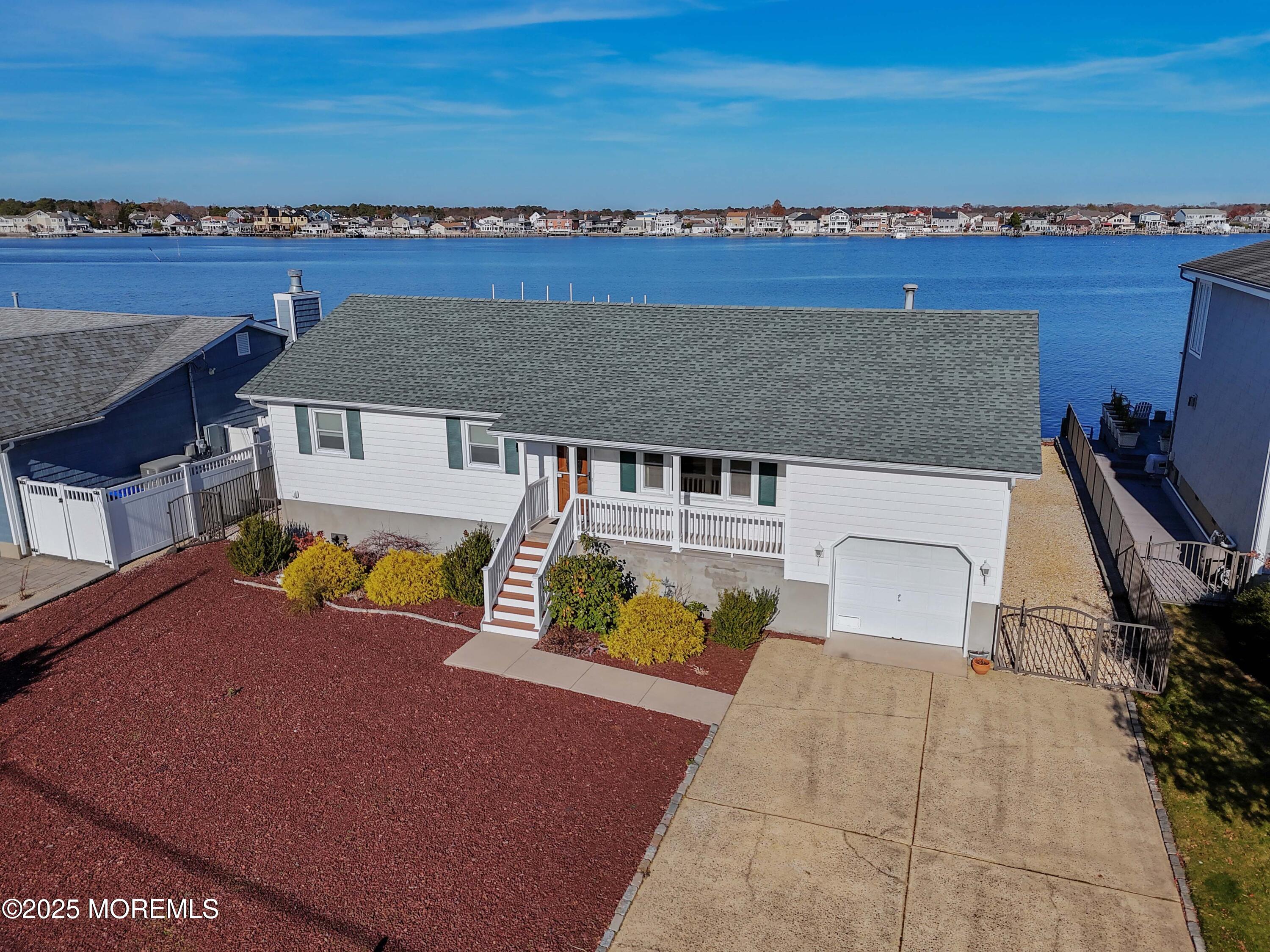 an aerial view of a house with swimming pool and ocean view