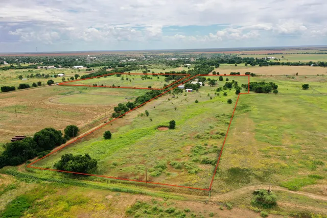 a bedroom with a bed wooden floor and window