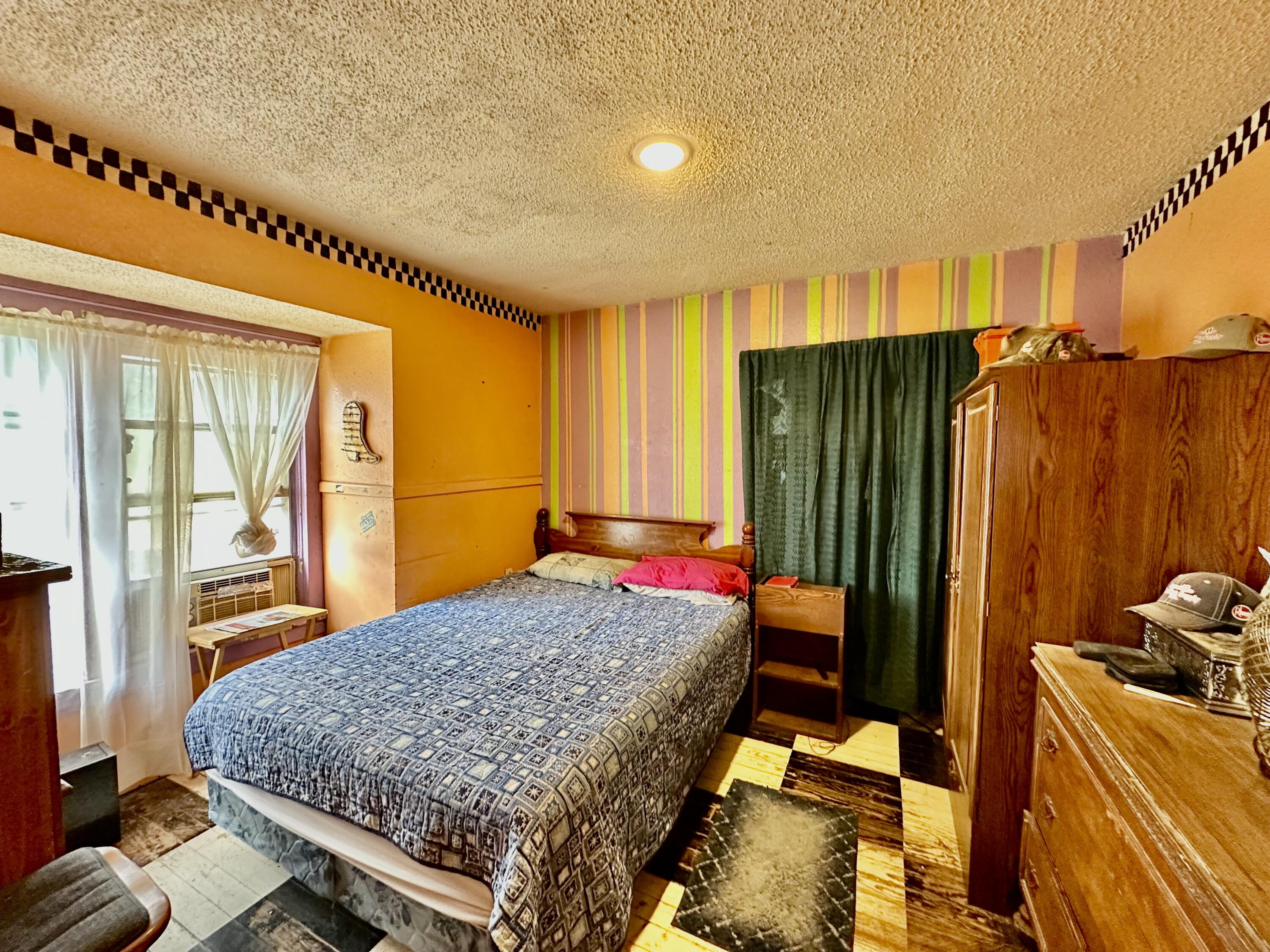 907 Co Road Turkey, TX 79261 - Photo 18 of 24 a bed room with a bed and a window