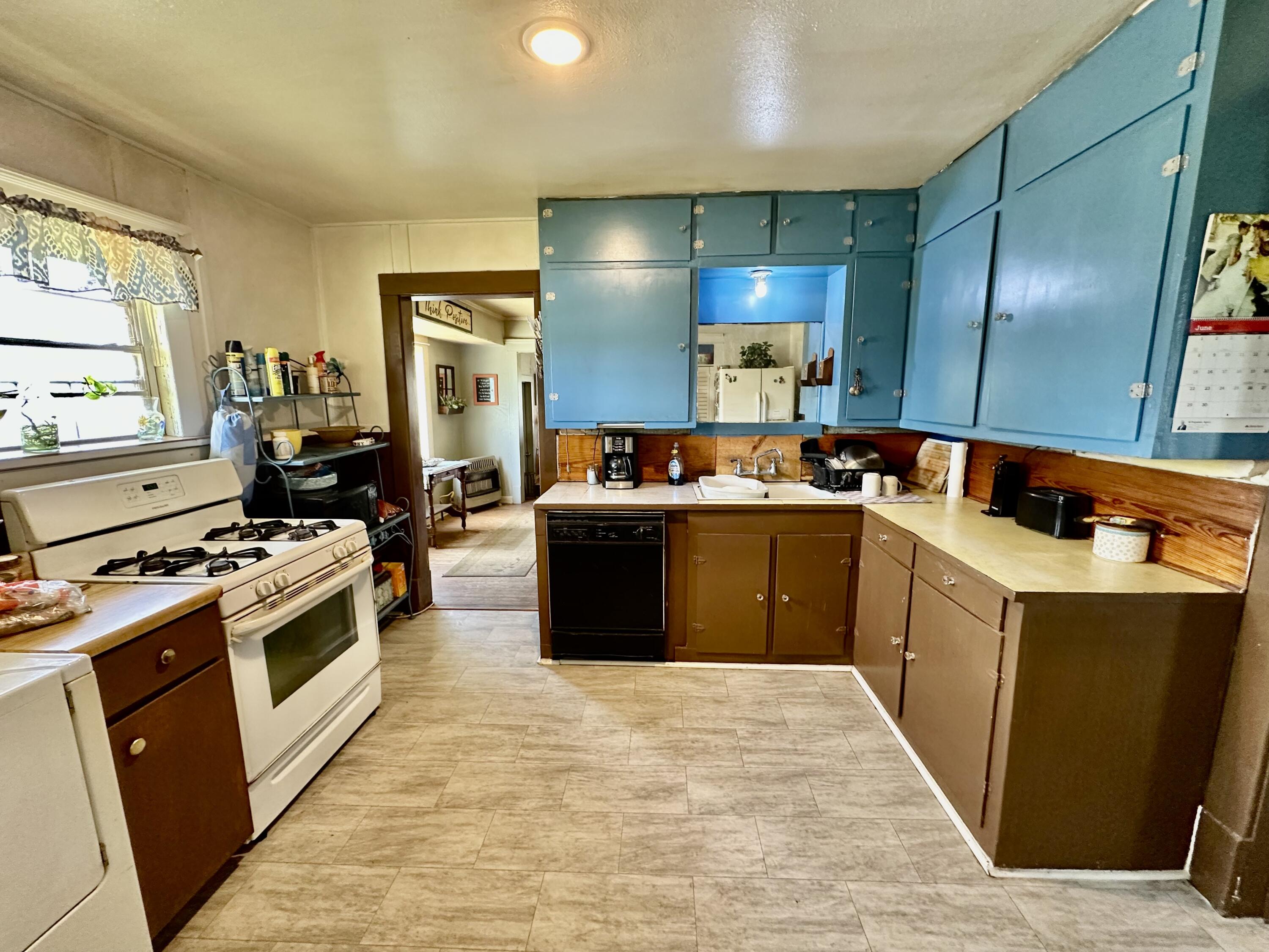 907 Co Road Turkey, TX 79261 - Photo 23 of 24 a kitchen with stainless steel appliances granite countertop a stove a sink dishwasher and a refrigerator