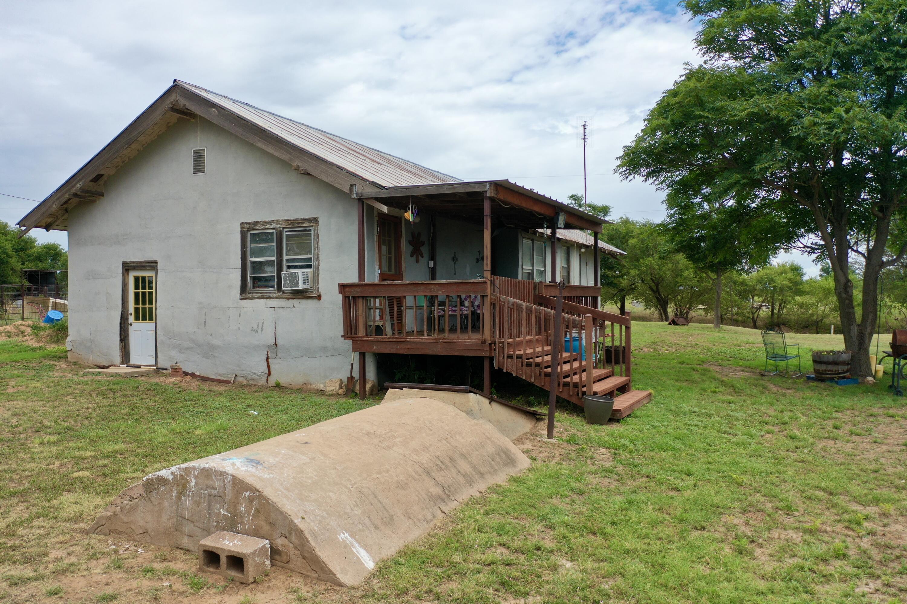 907 Co Road Turkey, TX 79261 - Photo 8 of 24 a view of a house with a yard