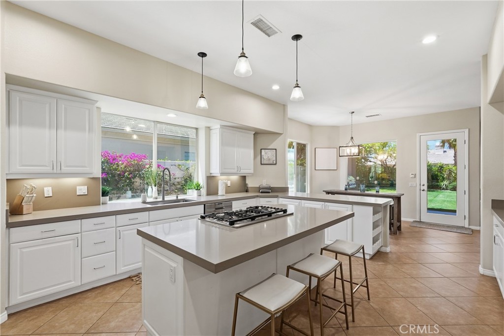 9 Orleans Road Rancho Mirage, CA 92270 - Photo 22 of 71 a kitchen with a counter space dining table and chairs
