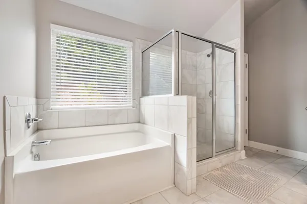 a bathroom with a bathtub and a shower