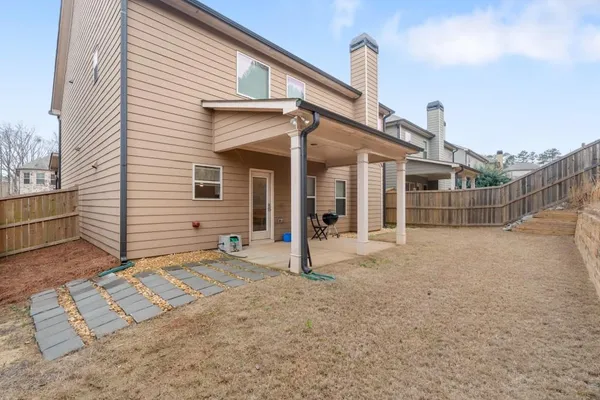 a view of a house with a backyard