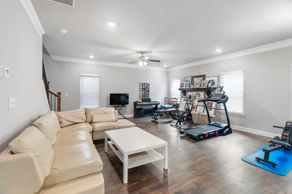 a living room with furniture and a wooden floor