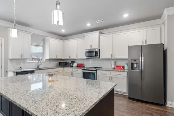 a bed room with a bed and a ceiling fan