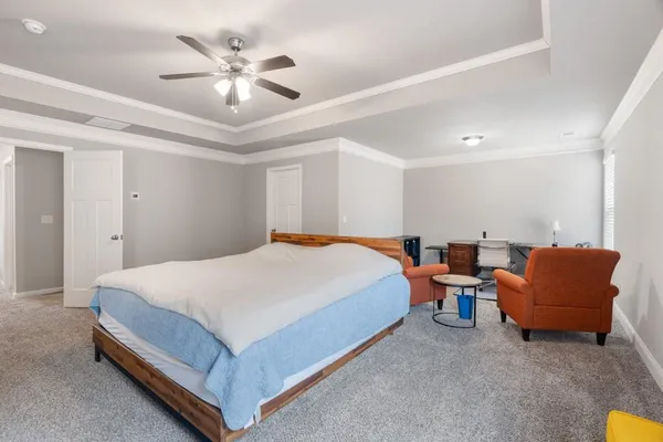 a living room with furniture a air conditioner and a window