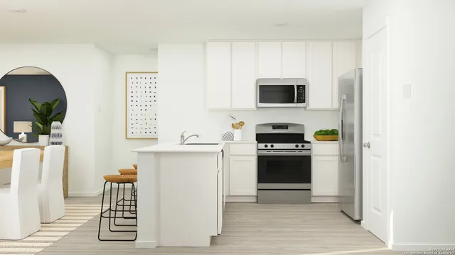 a kitchen with a refrigerator and a stove top oven