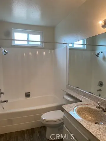 a bathroom with a granite countertop toilet a sink and bathtub