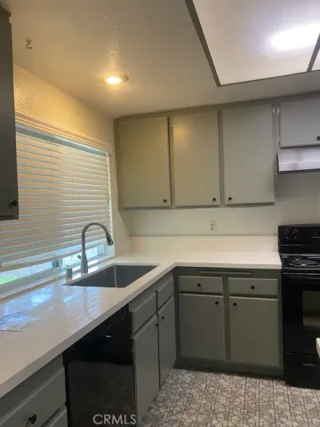 a kitchen with a sink and cabinets