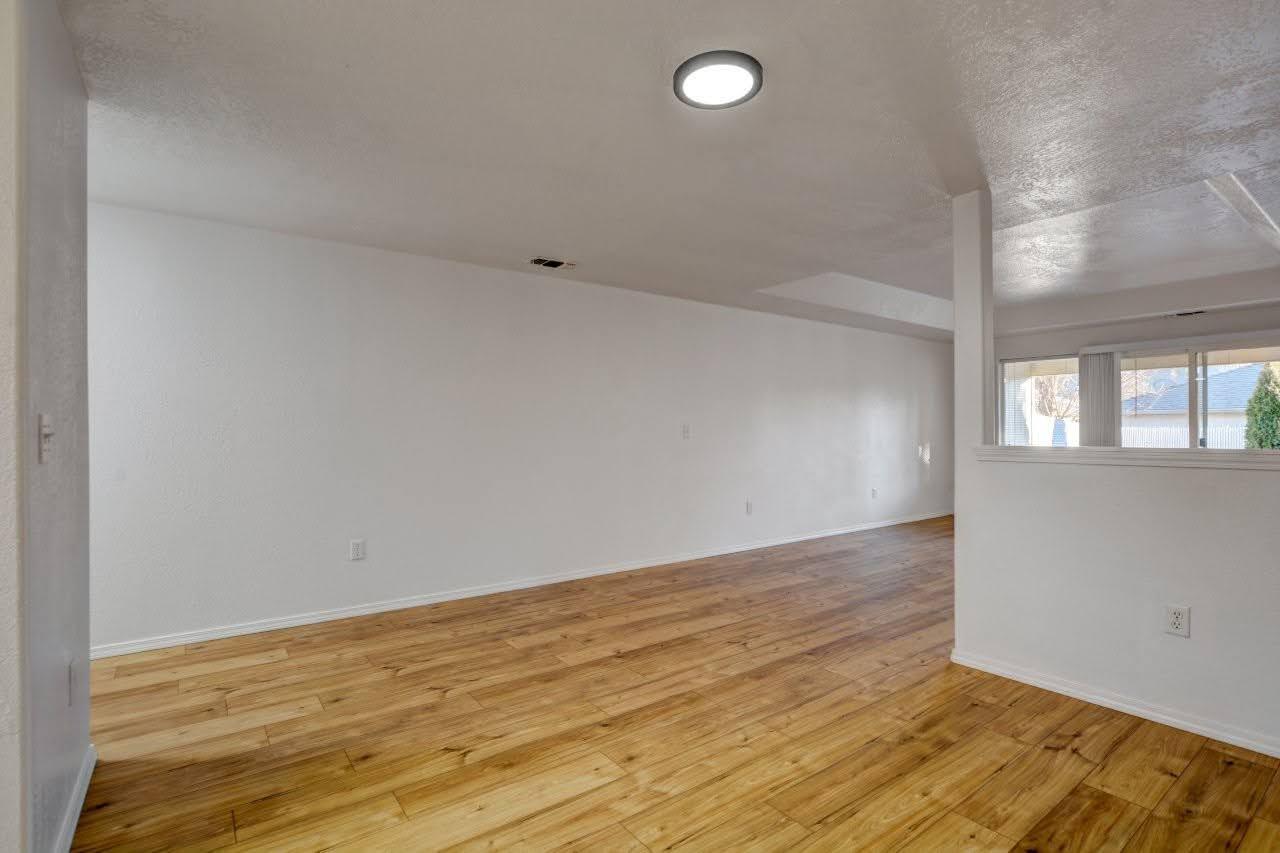417 Crystal Drive Eagle Point, OR 97524 - Photo 8 of 35 an empty room with wooden floor and windows