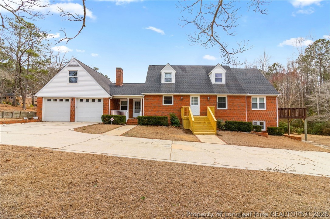 3488 School Road Fayetteville, NC 28306 - Photo 1 of 50 a front view of a house with a yard and garage