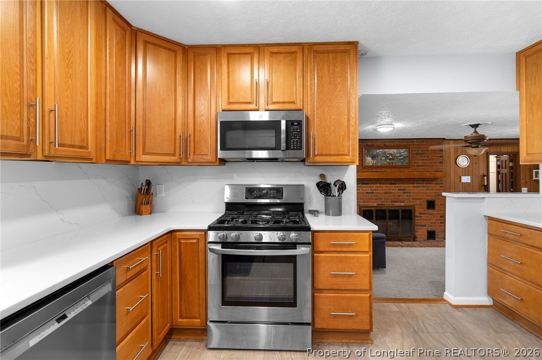 3488 School Road Fayetteville, NC 28306 - Photo 11 of 50 a kitchen with a stove and a microwave
