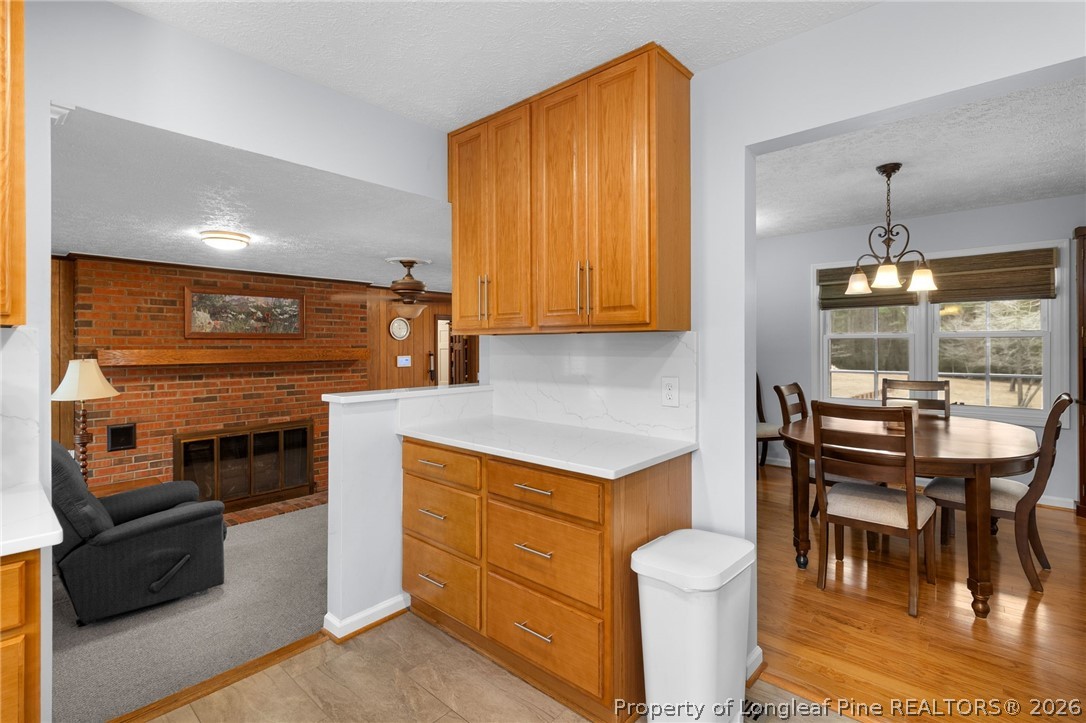 3488 School Road Fayetteville, NC 28306 - Photo 13 of 50 a kitchen with a stove a refrigerator and a dining table