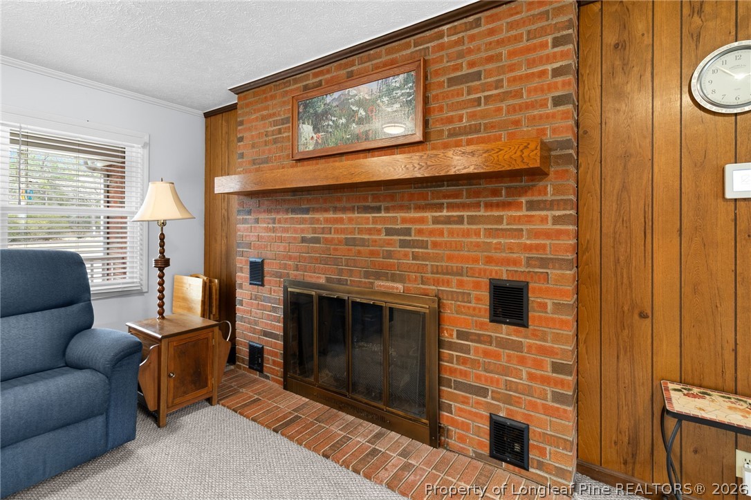 3488 School Road Fayetteville, NC 28306 - Photo 15 of 50 a living room with furniture a flat screen tv and a fireplace