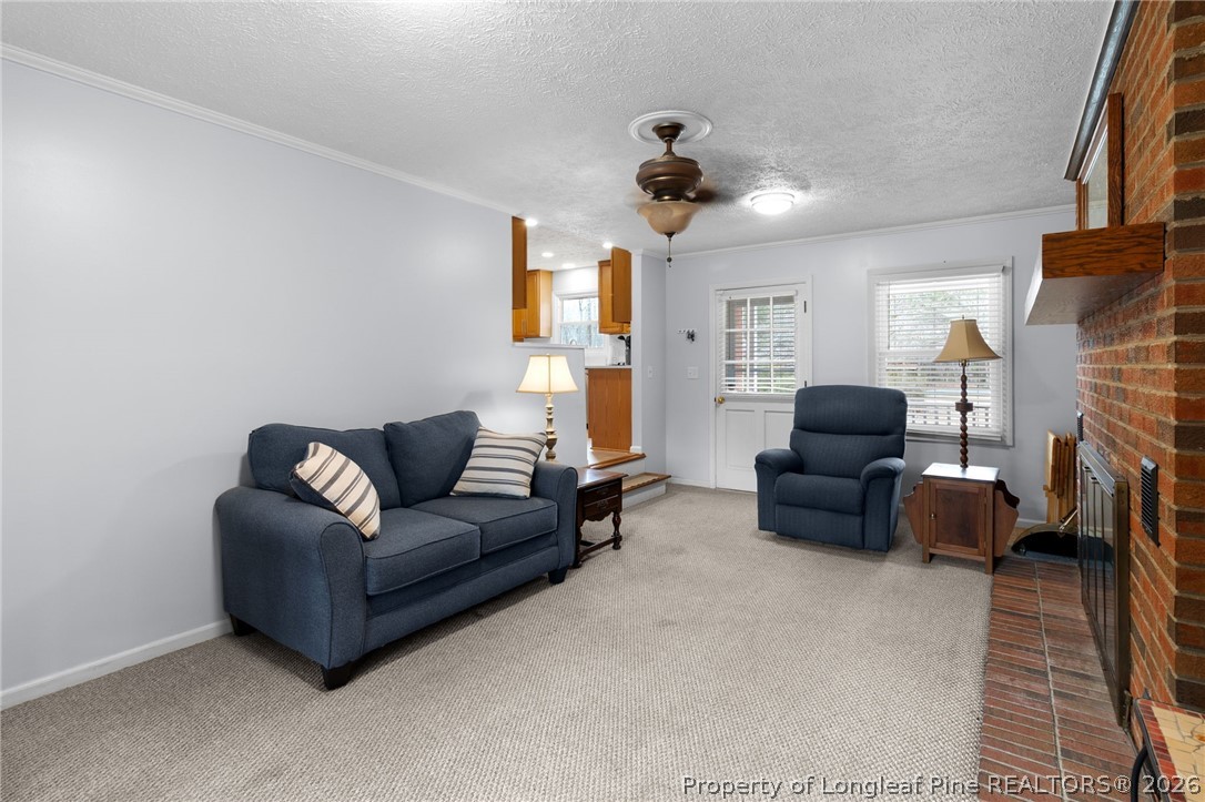 3488 School Road Fayetteville, NC 28306 - Photo 16 of 50 a living room with furniture and a fireplace