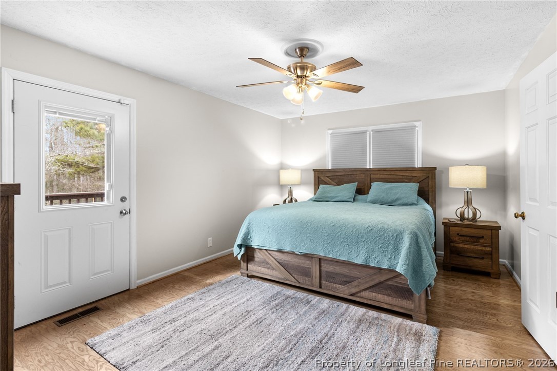 3488 School Road Fayetteville, NC 28306 - Photo 20 of 50 a bedroom with a bed and wooden floor