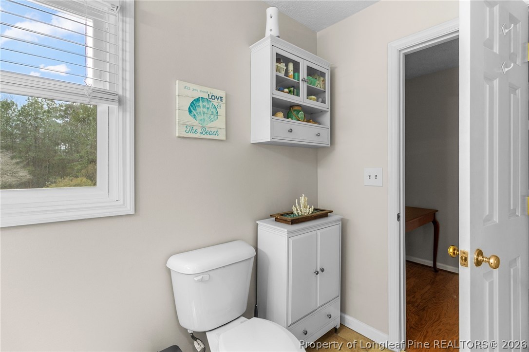 3488 School Road Fayetteville, NC 28306 - Photo 24 of 50 a white toilet sitting next to a bathroom sink