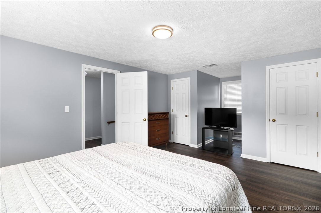 3488 School Road Fayetteville, NC 28306 - Photo 27 of 50 a bedroom with a bed and a flat screen tv