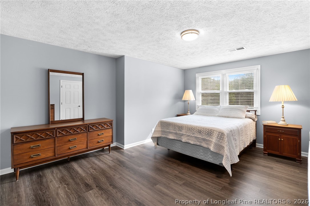 3488 School Road Fayetteville, NC 28306 - Photo 28 of 50 a bedroom with a bed and wooden floor