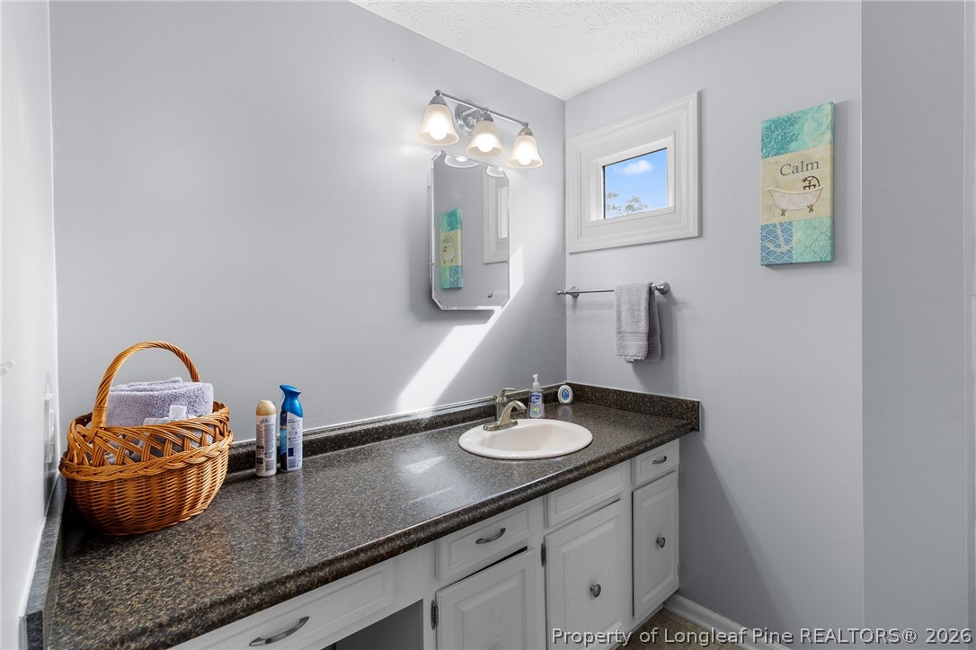 3488 School Road Fayetteville, NC 28306 - Photo 29 of 50 a bathroom with a sink and a mirror