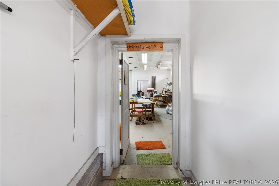 3488 School Road Fayetteville, NC 28306 - Photo 40 of 50 a hallway with a white stove and a refrigerator
