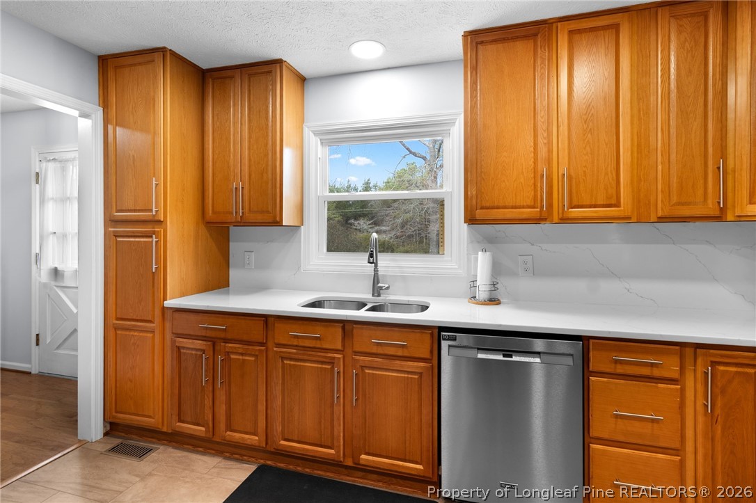 3488 School Road Fayetteville, NC 28306 - Photo 10 of 50 a kitchen with a sink a window and cabinets