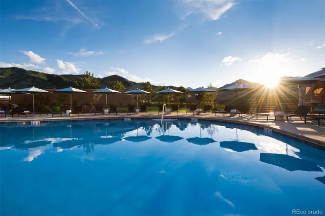 a view of a swimming pool with an outdoor seating