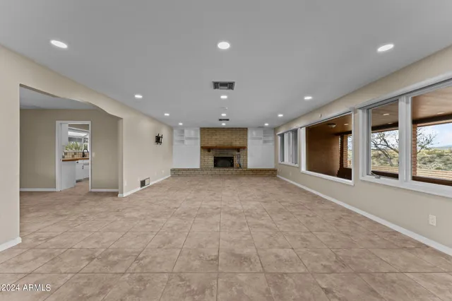 a view of an empty room with a fireplace