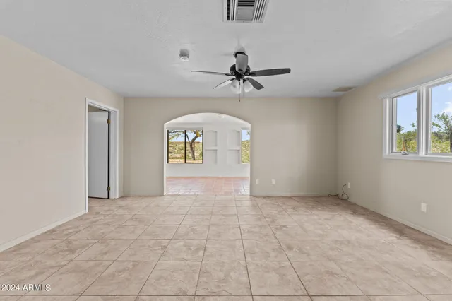 a view of hallway with windows and chandelier