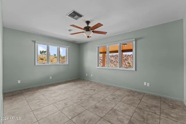 a bathroom with a granite countertop sink a mirror and shower