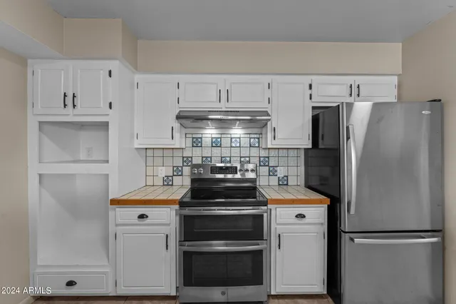 a view of a livingroom with an empty space and a window