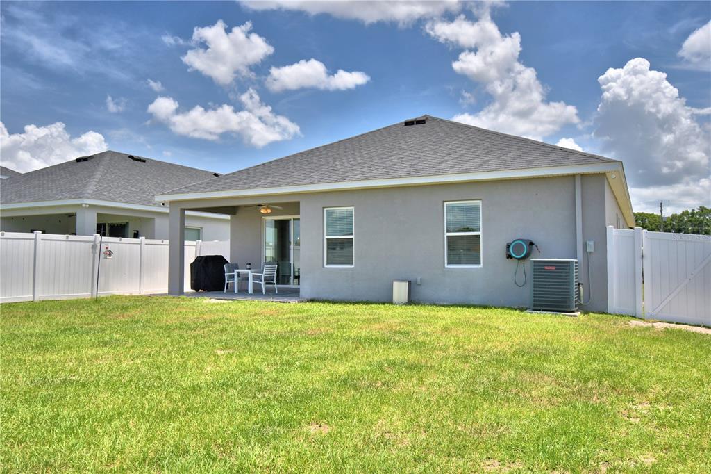 4340 Reding Way Lakeland, FL 33813 - Photo 58 of 63 a view of a house with a yard and a large tree